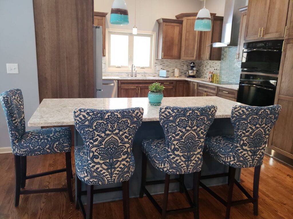 Kitchen island with seating, stained cabinets and patterned bar stools by Kitchen Express