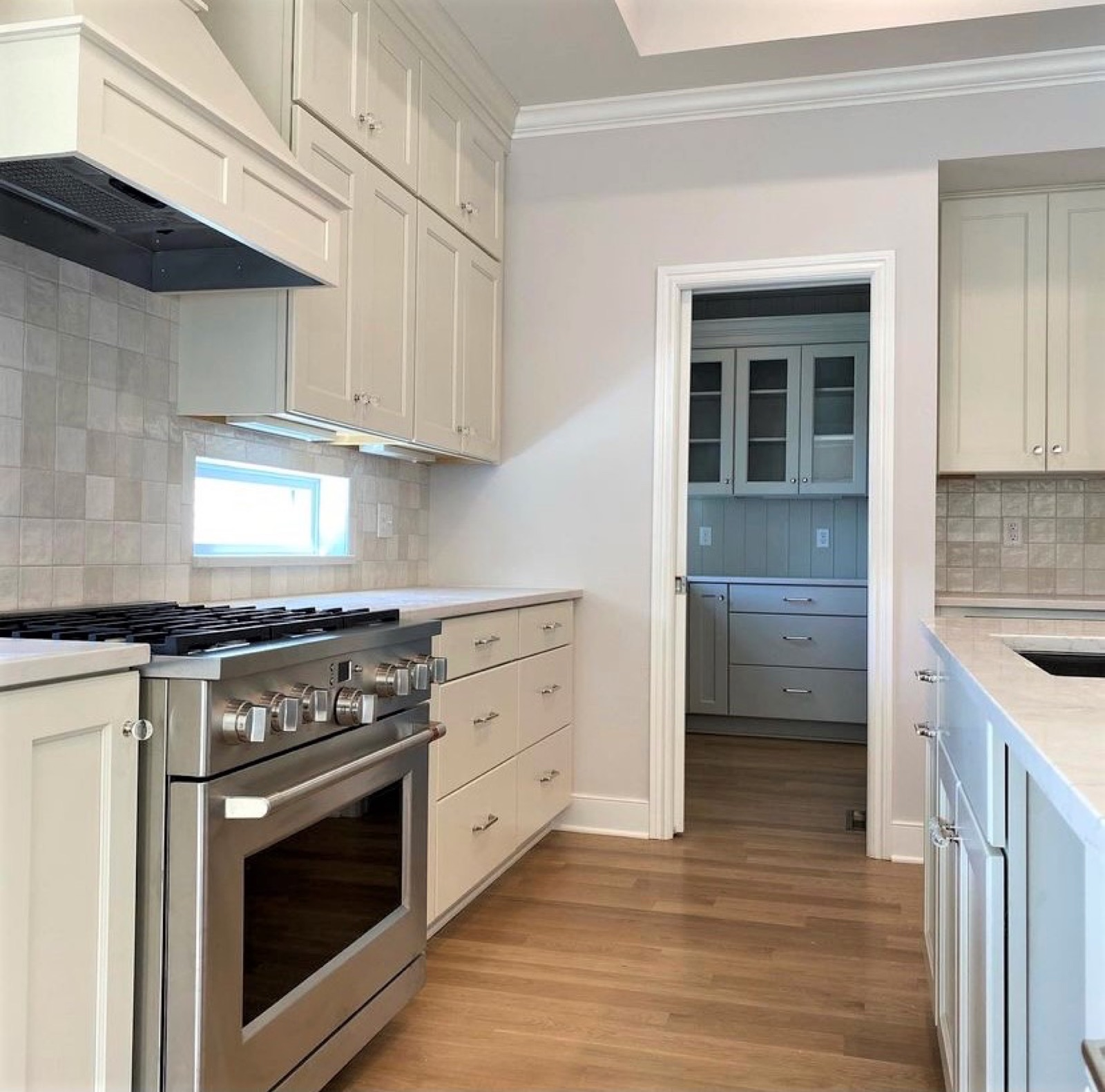 Large kitchen island with seating in an open-concept model kitchen by Kitchen Express