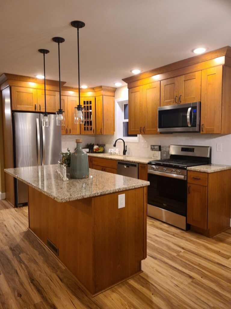 Traditional oak shaker kitchen with granite counters, center island and stainless appliances by Kitchen Express, Syracuse NY