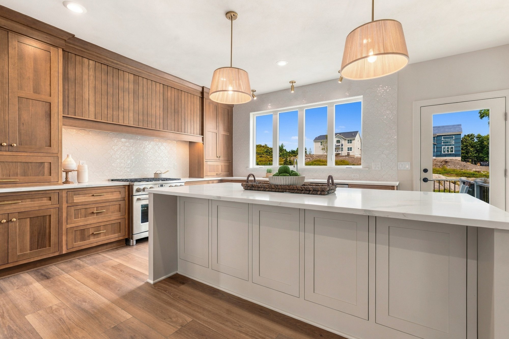 Cordelle Custom Homes 2026 Parade of Homes — Island beneath a wall of windows